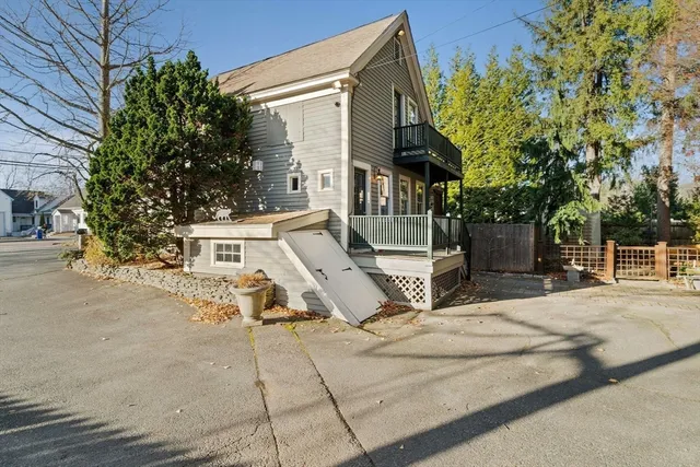 a view of a house with a yard and pathway