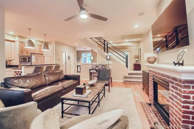 a living room with furniture a ceiling fan and a rug