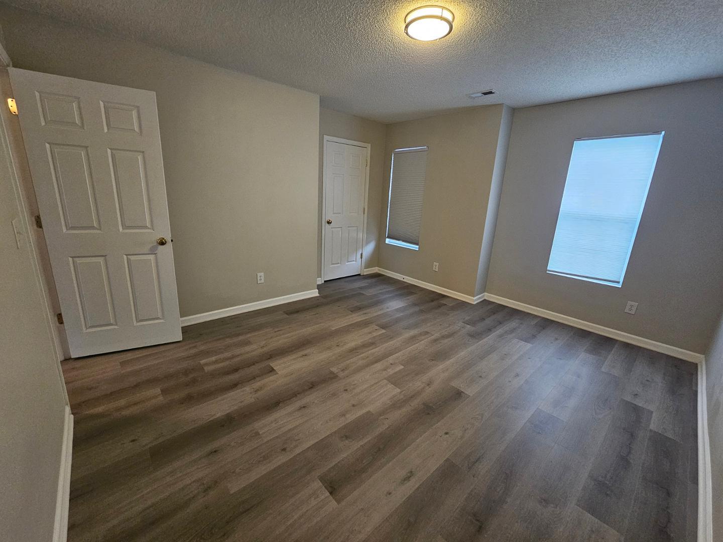 2341 Brasstown Lane Apex, NC 27502 - Photo 14 of 24 an empty room with wooden floor and windows