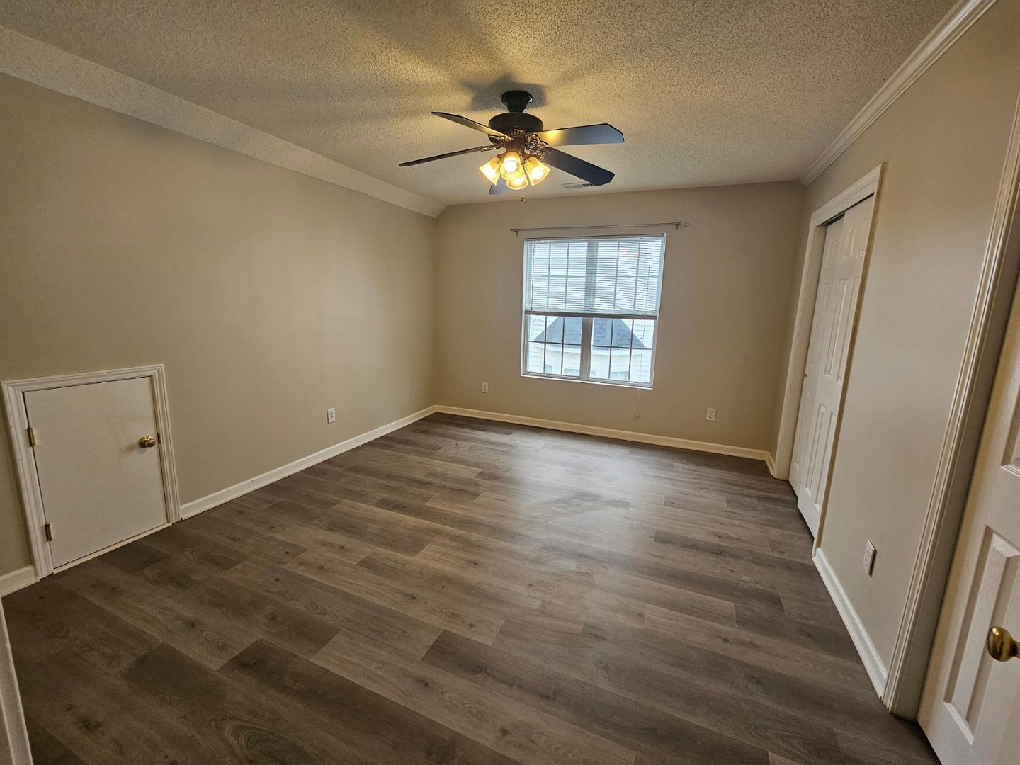 2341 Brasstown Lane Apex, NC 27502 - Photo 16 of 24 a view of an empty room with wooden floor and a window