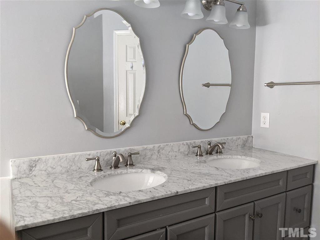 2341 Brasstown Lane Apex, NC 27502 - Photo 19 of 24 a bathroom with double vanity sinks and a mirror
