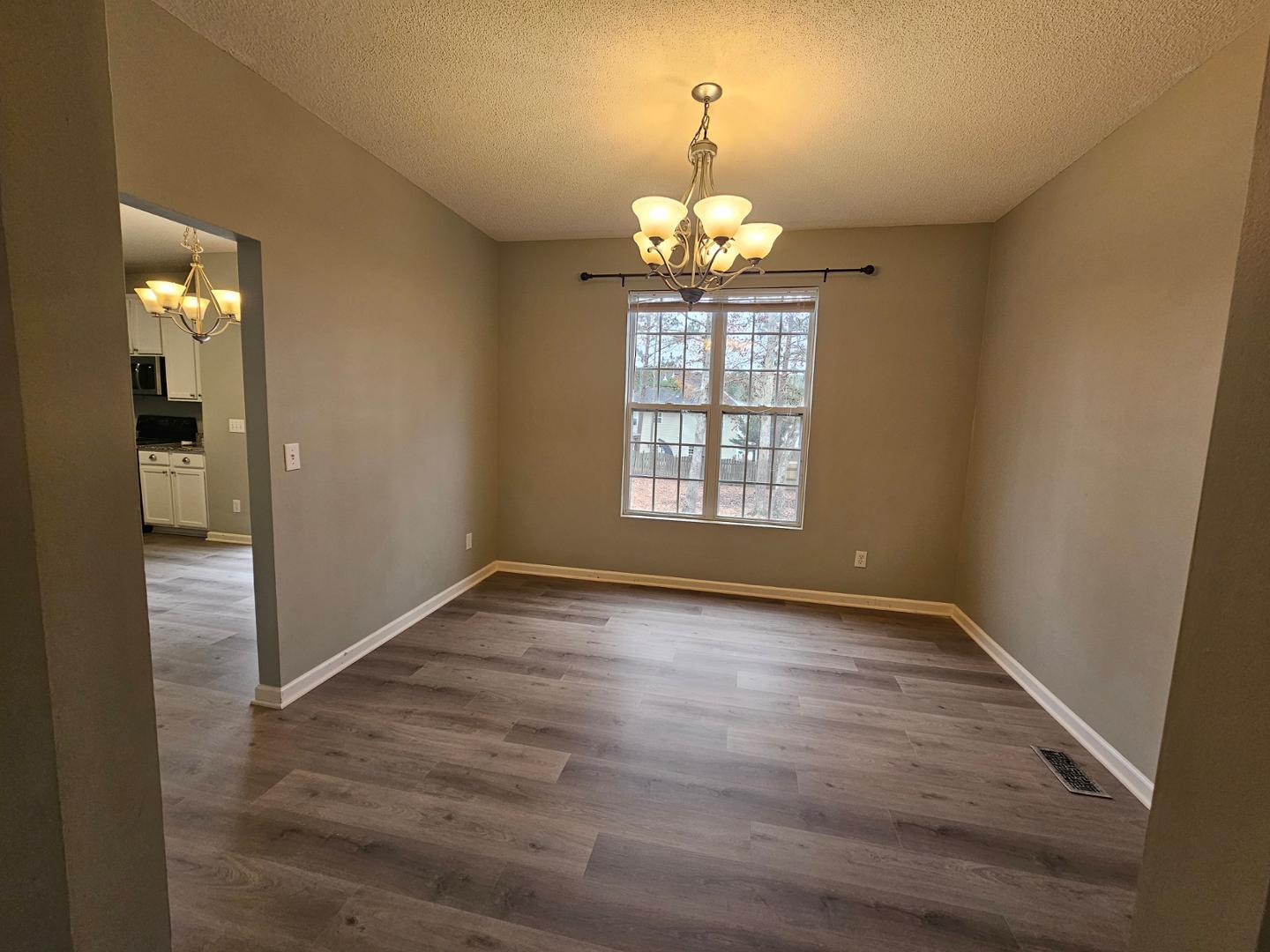 2341 Brasstown Lane Apex, NC 27502 - Photo 6 of 24 wooden floor in an empty room with a window