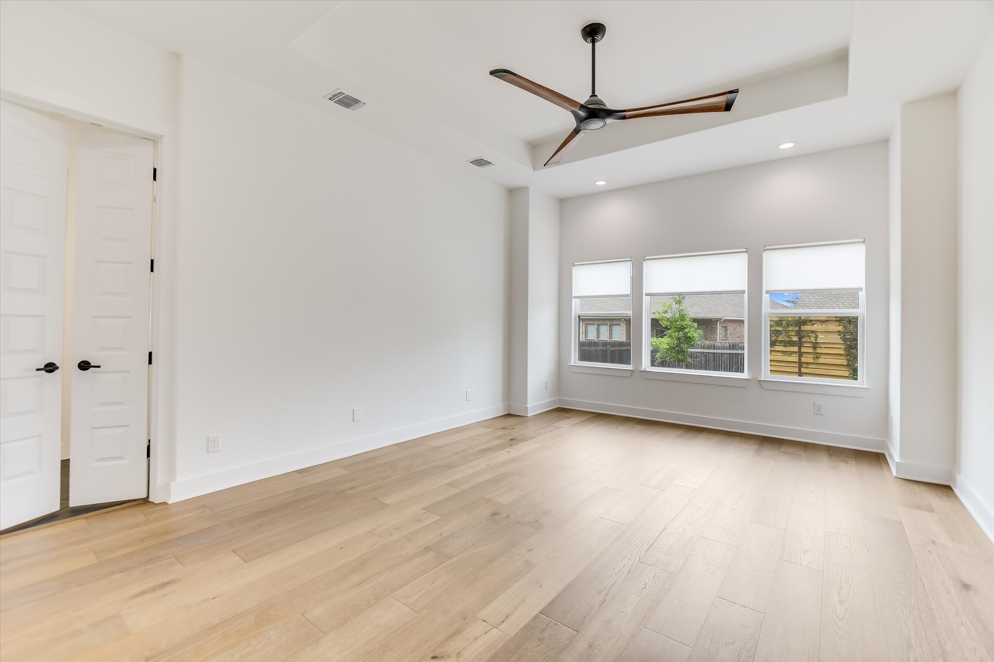 4300 Allenbrook Drive Pflugerville, TX 78660 - Photo 20 of 40 a view of a room with wooden floor ceiling fan and windows