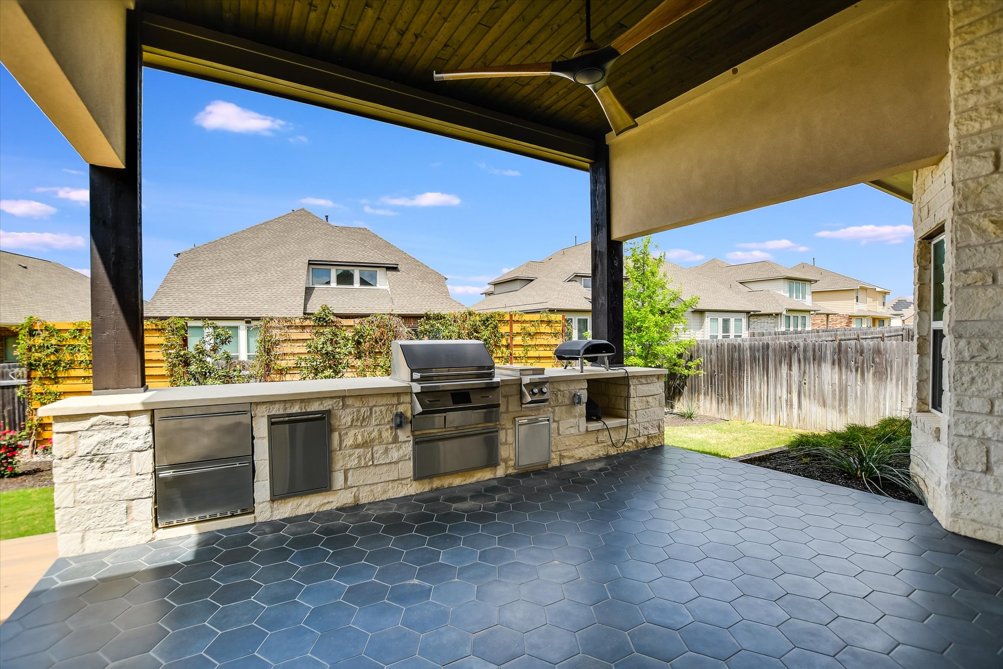 4300 Allenbrook Drive Pflugerville, TX 78660 - Photo 37 of 40 a view of a outdoor kitchen with a large window