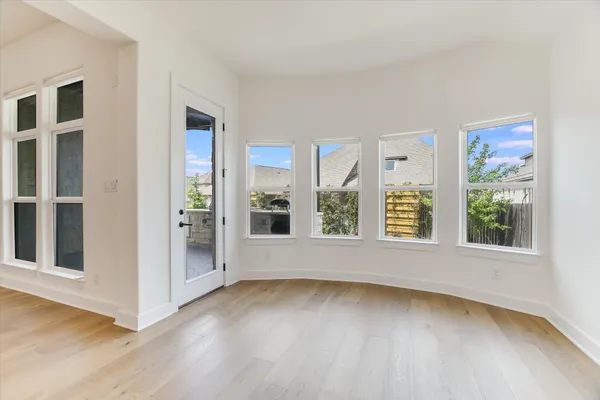 a view of a room with wooden floor
