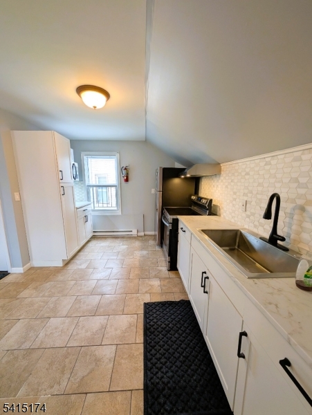 437 East 21st Street Paterson, NJ 07513 - Photo 5 of 12 a large kitchen with a stove and a sink