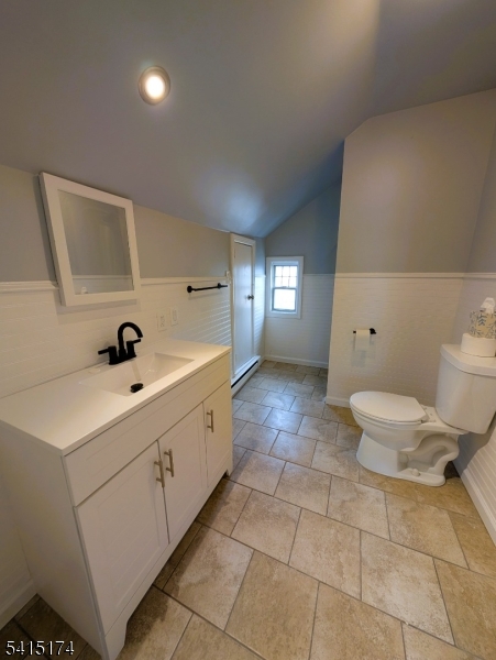 437 East 21st Street Paterson, NJ 07513 - Photo 6 of 12 a spacious bathroom with a double vanity sink toilet and a mirror