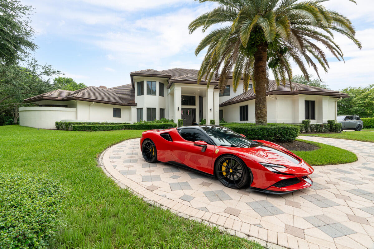 3500 Windmill Ranch Road Weston, FL 33331 - Photo 5 of 47 a front view of a house with a garden and plants