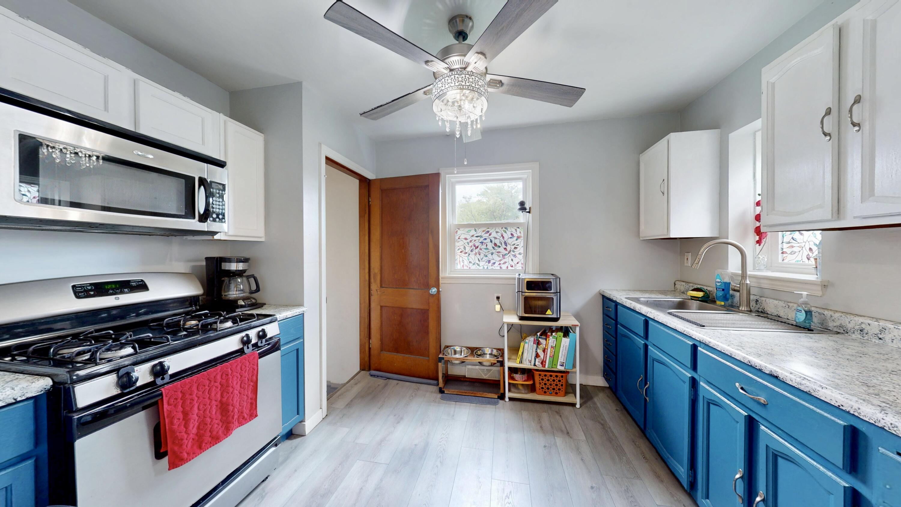 7335 Tapper Avenue Hammond, IN 46324 - Photo 11 of 36 a kitchen with stainless steel appliances a stove cabinets and wooden floor