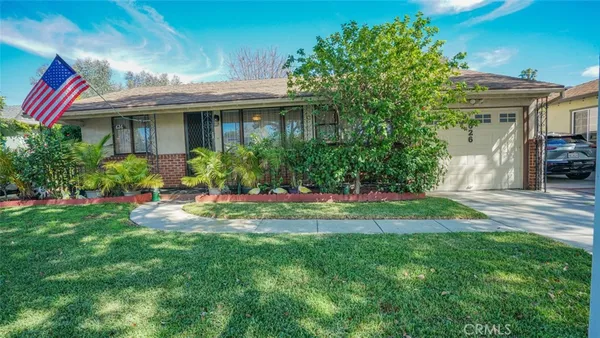 a view of a house with a yard and sitting area