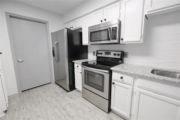 a view of a kitchen with electric appliances