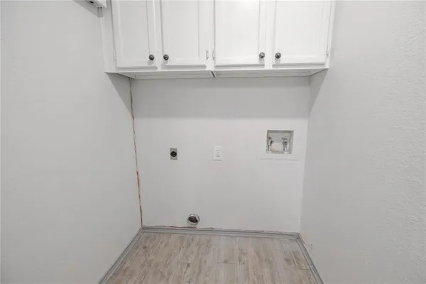 a kitchen with white cabinets stainless steel appliances and sink