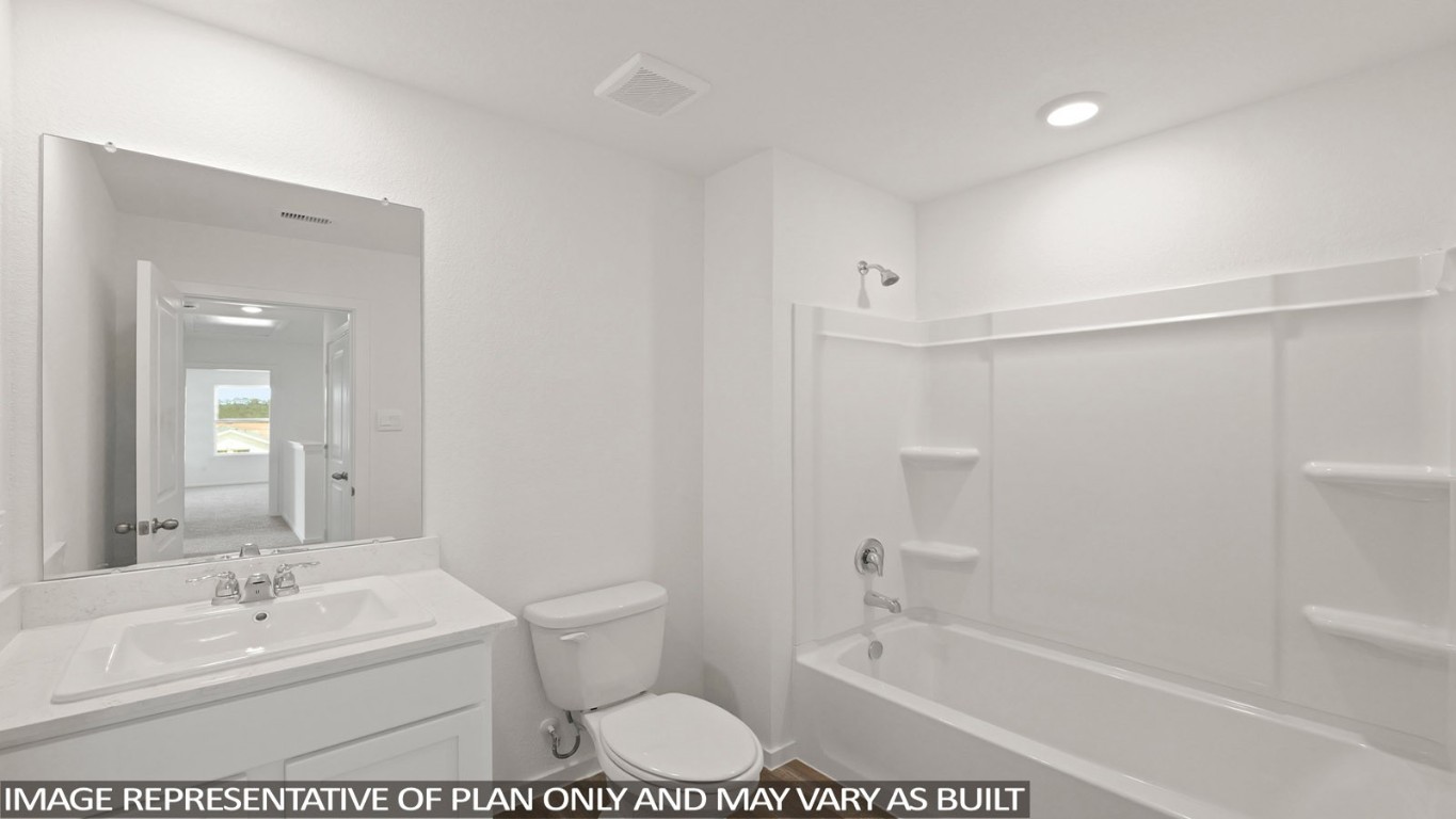 11679 Ruffian Drive Willis, TX 77318 - Photo 11 of 26 a bathroom with a bathtub shower sink vanity and toilet