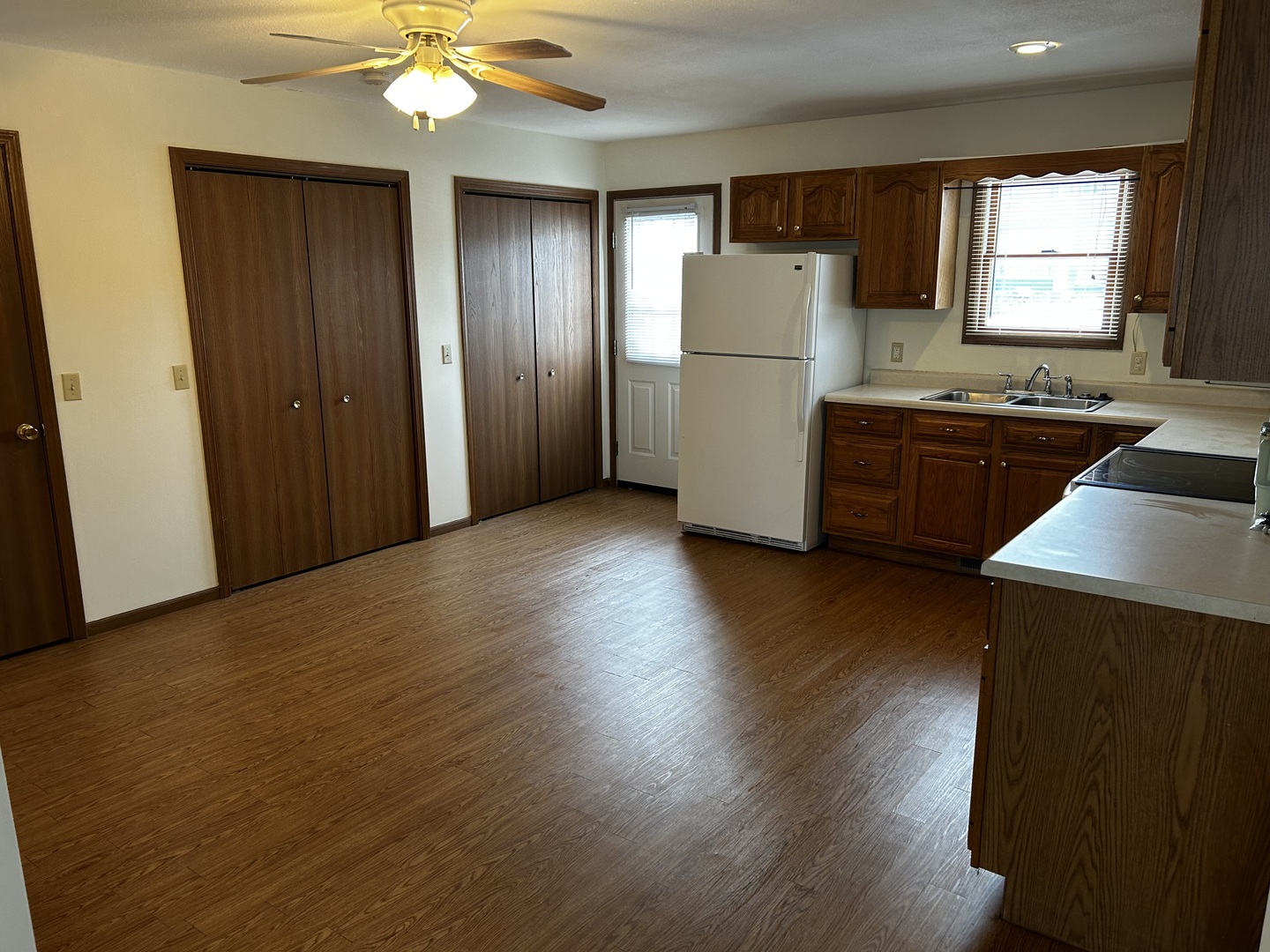 107 South Oak Street Assumption, IL 62510 - Photo 4 of 11 a kitchen with kitchen island wooden floors appliances and window