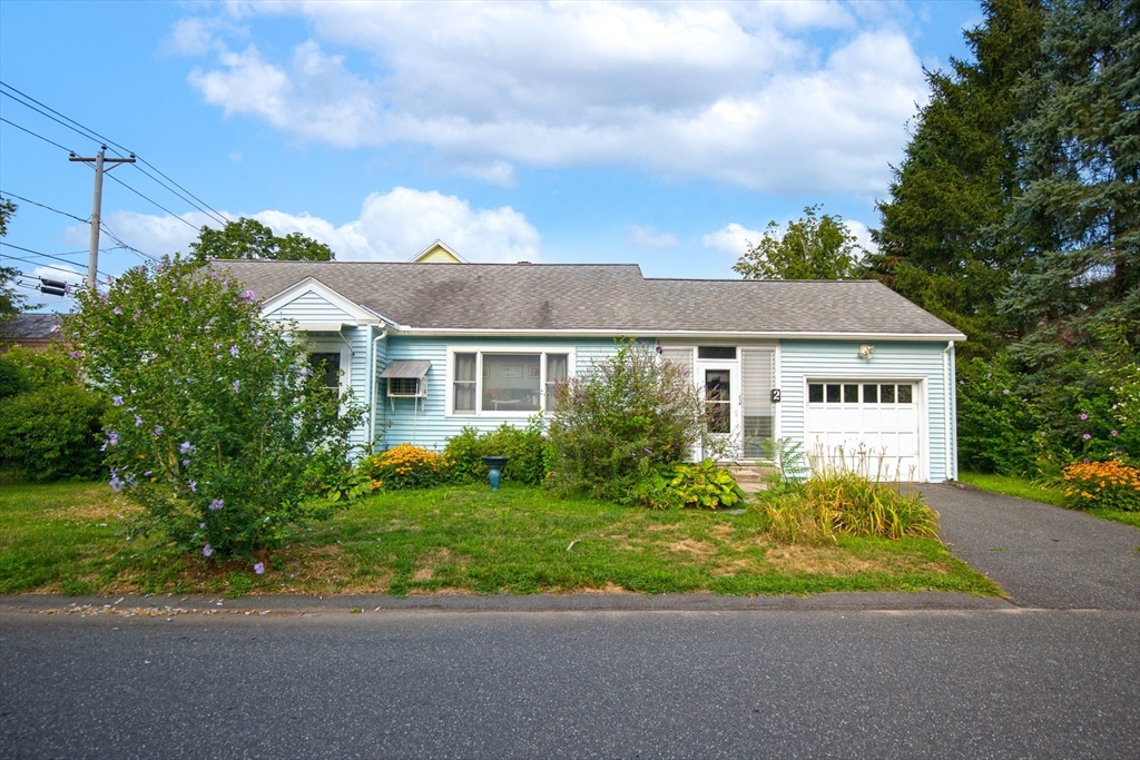 a front view of house with yard and green space