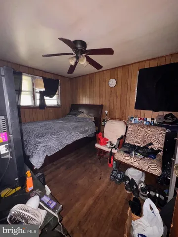 a spacious bedroom with a bed and a chandelier