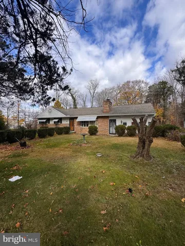 a view of a lake with a big yard and large trees