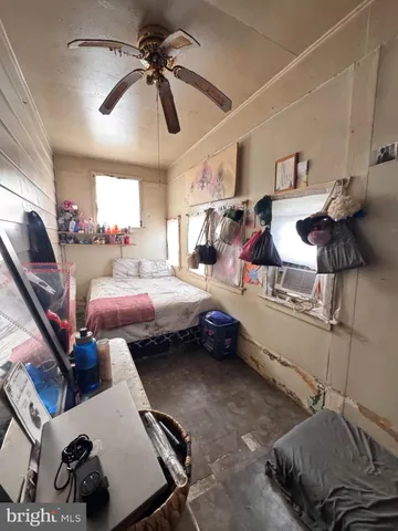 a living room with furniture and a ceiling fan