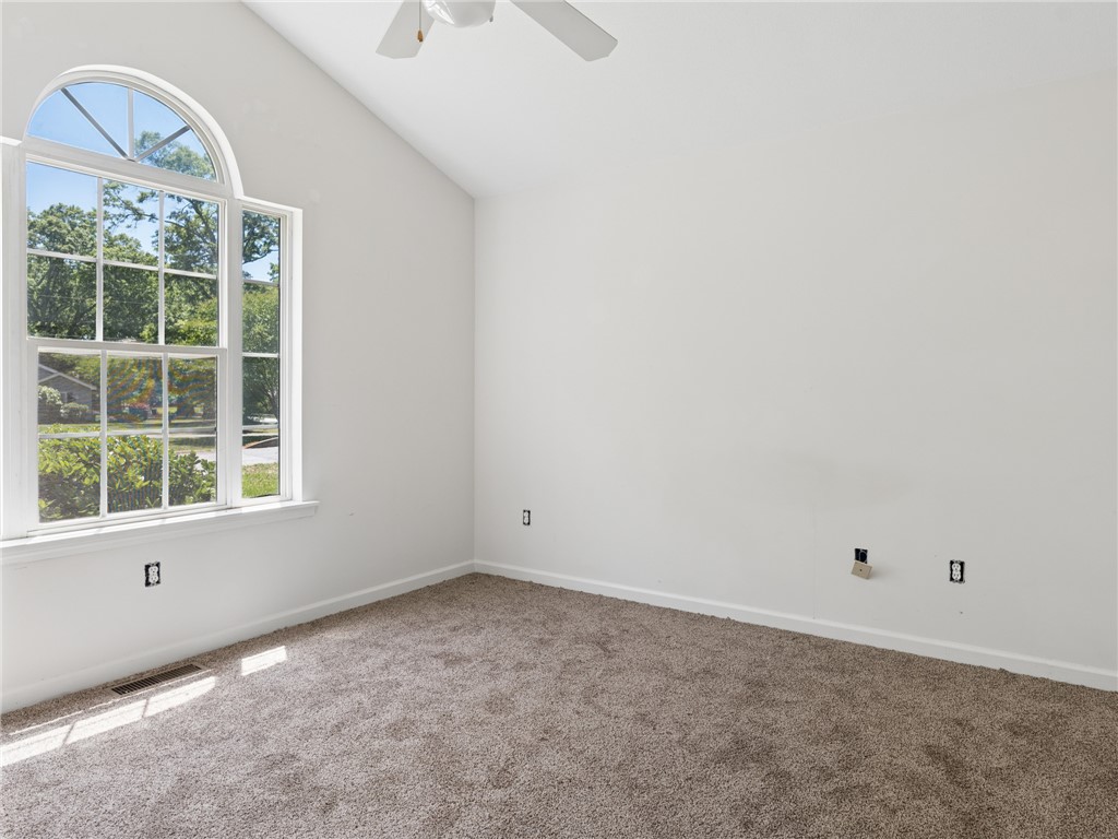 101 Woodbridge Circle Anderson, SC 29621 - Photo 11 of 21 This airy room features a large arched window, vaulted ceilings, and soft carpet.