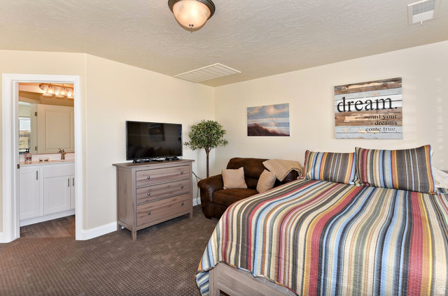 1622 Canyon Tree Drive St. George, UT 84770 - Photo 21 of 34 Carpeted bedroom featuring a light fixture, recessed ceiling vent, and neutral wall color