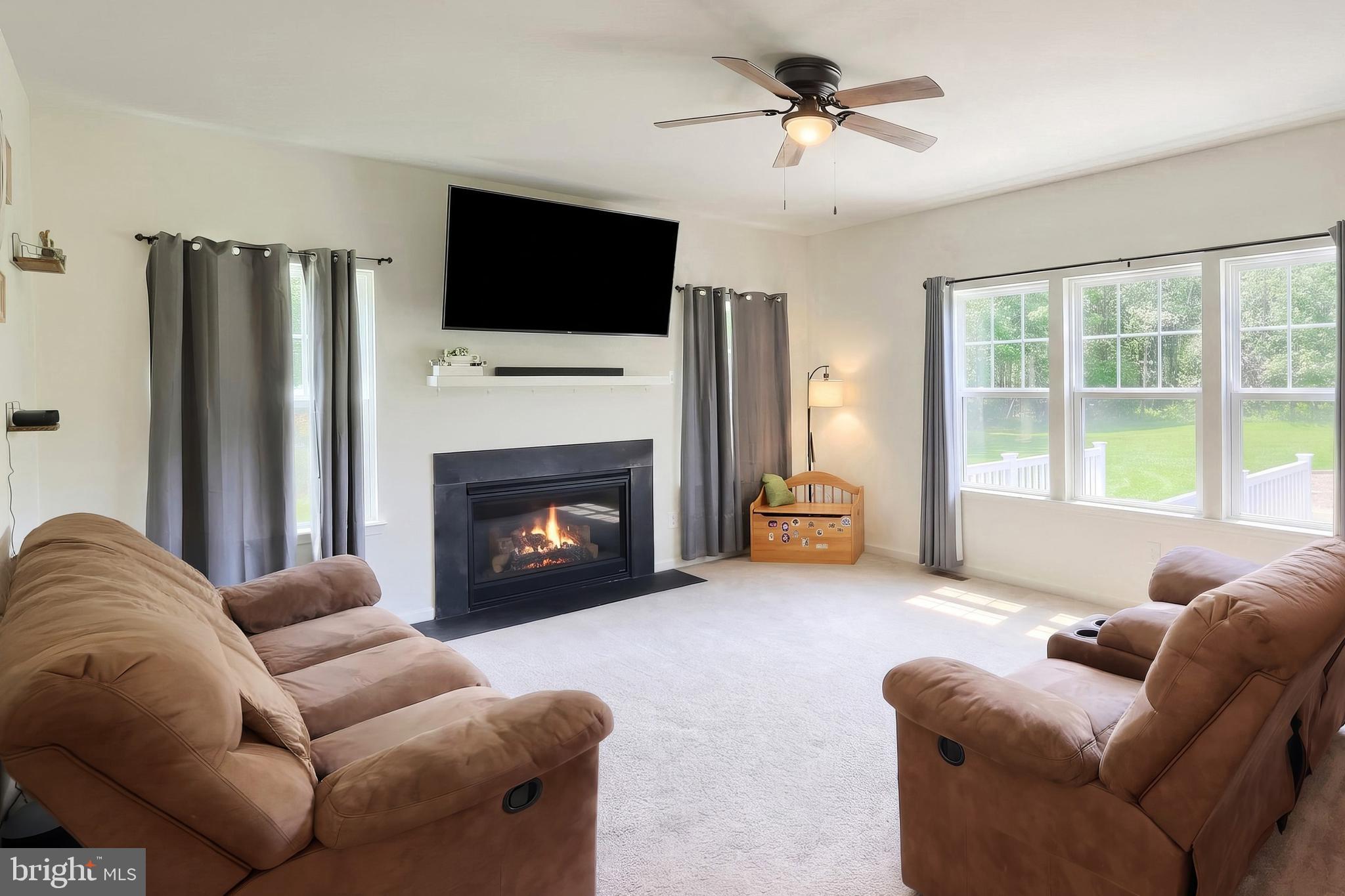 2741 Cold Springs Road Orrtanna, PA 17353 - Photo 16 of 52 a living room with furniture a fireplace and a flat screen tv