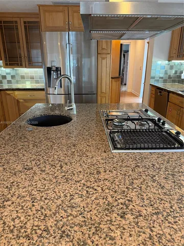 a kitchen with stainless steel appliances granite countertop a stove and a microwave