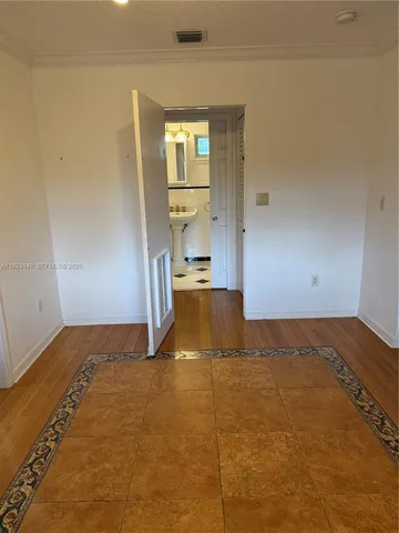 a view of an empty room with a kitchen