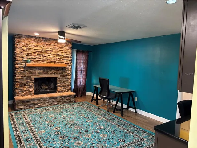 a bathroom with a granite countertop toilet sink and mirror