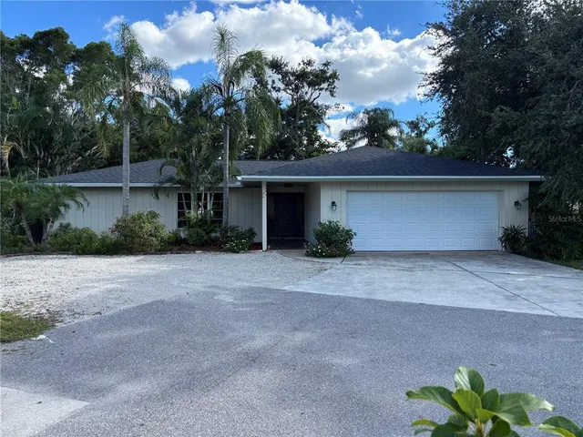 a front view of a house with a yard and a garage