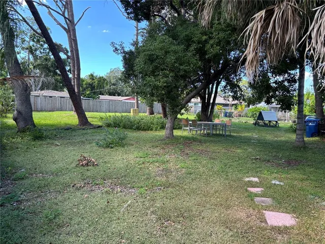a view of a park with large trees