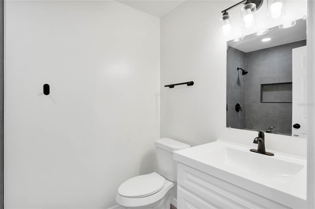 448 Ridge Drive Sanford, FL 32773 - Photo 8 of 20 a bathroom with a sink a toilet and shower