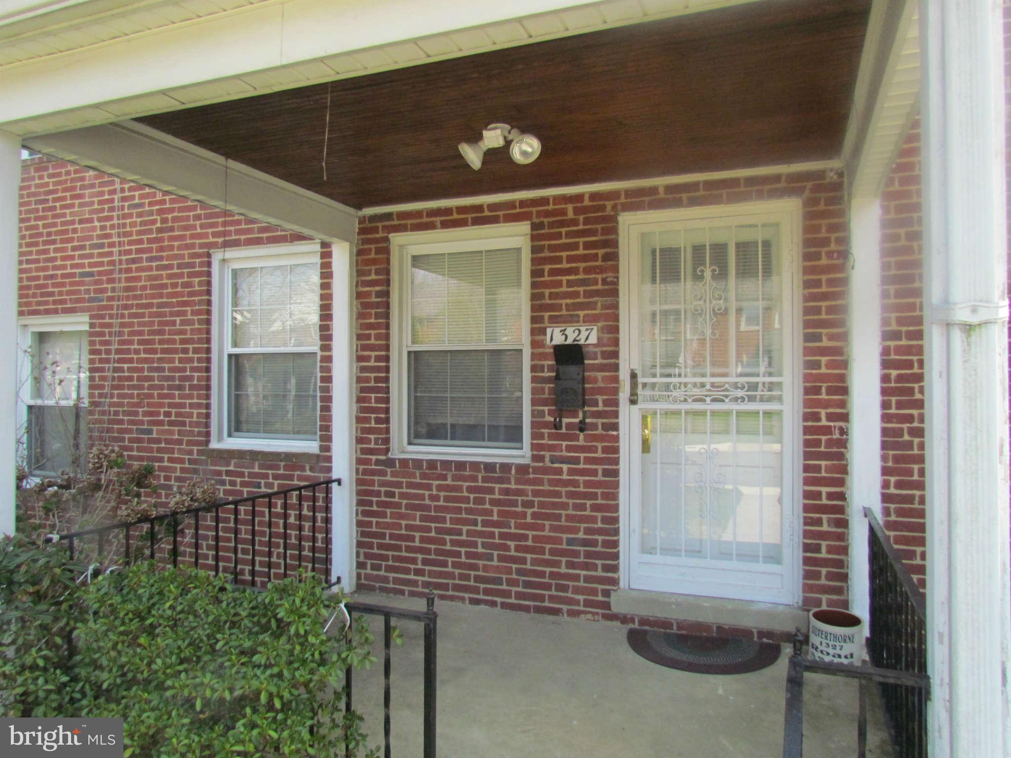 1327 Silverthorne Road Baltimore, MD 21239 - Photo 1 of 16 a view of brick house with a door