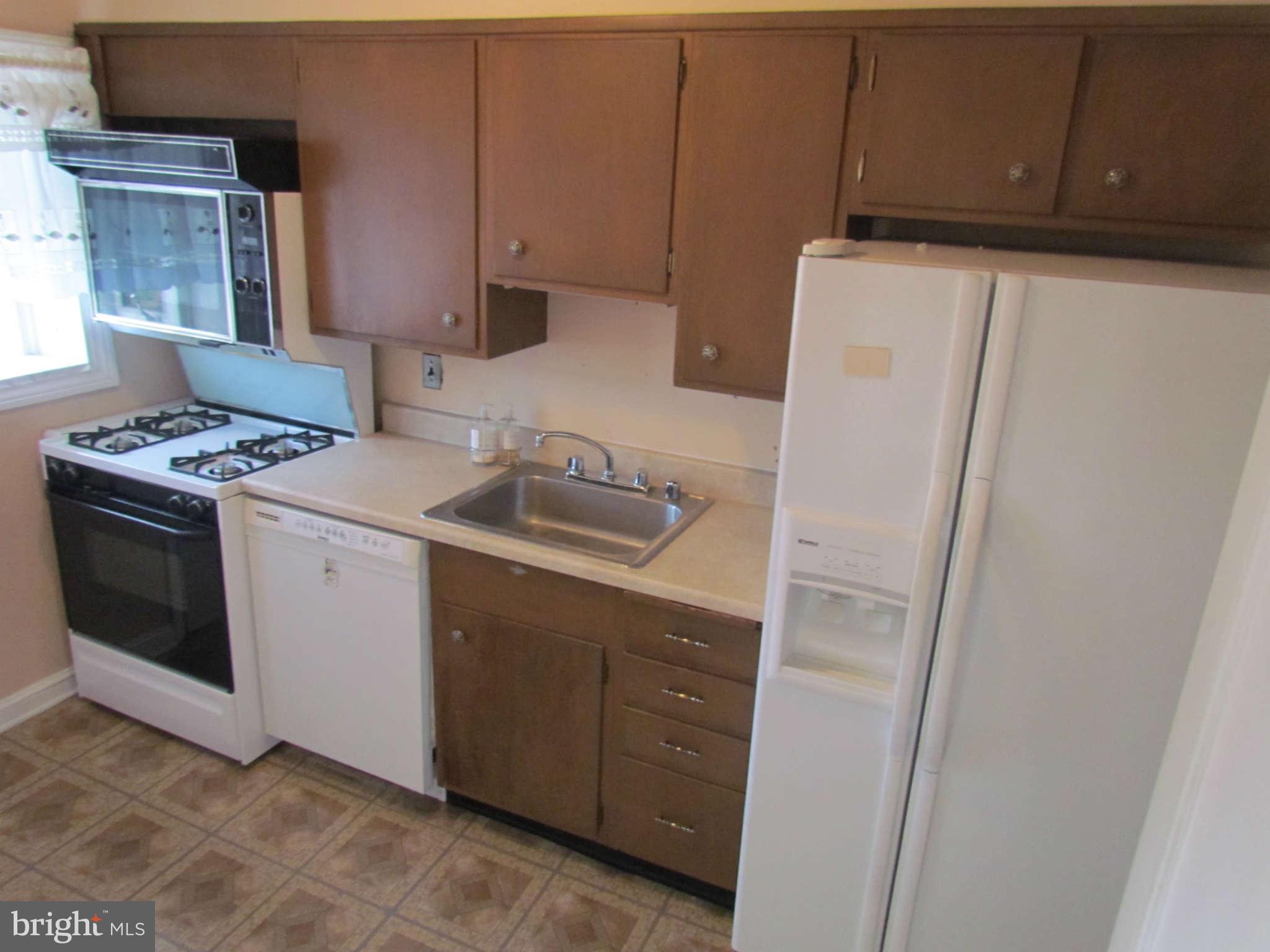 1327 Silverthorne Road Baltimore, MD 21239 - Photo 13 of 16 a utility room with sink dryer and washer