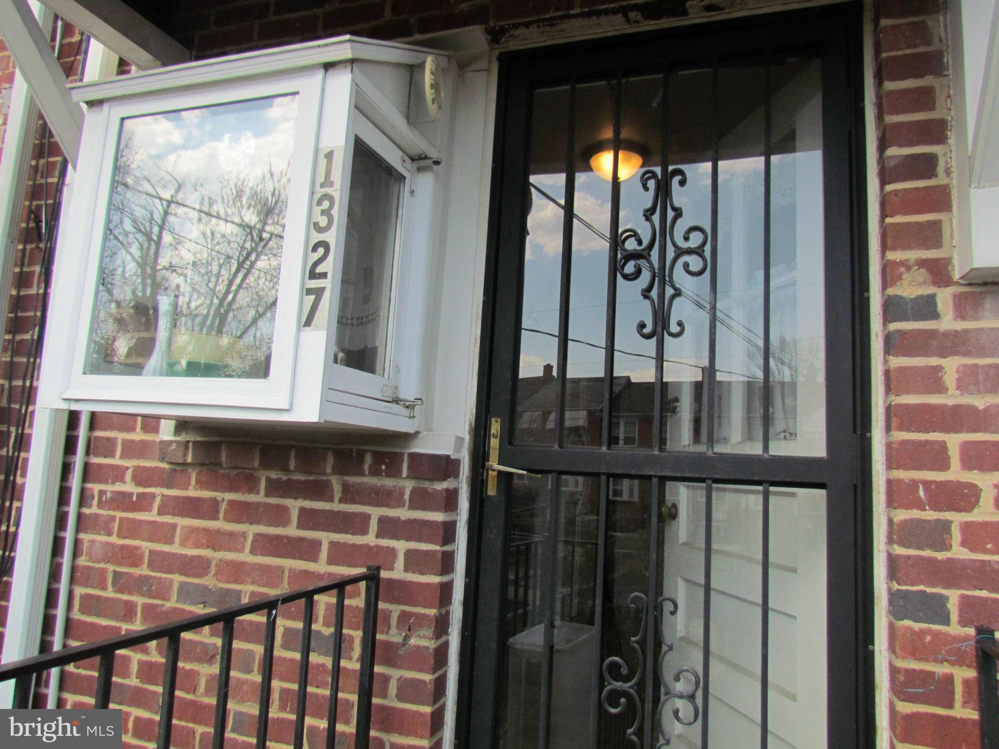 1327 Silverthorne Road Baltimore, MD 21239 - Photo 15 of 16 a front view of a house with a glass door
