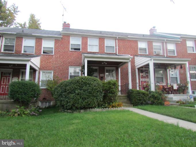 1327 Silverthorne Road Baltimore, MD 21239 - Photo 16 of 16 a front view of a house with garden and porch