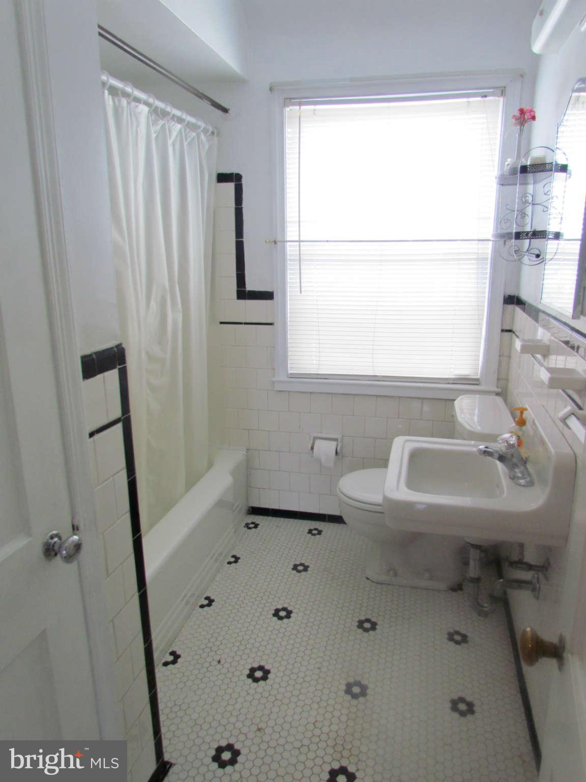 1327 Silverthorne Road Baltimore, MD 21239 - Photo 9 of 16 a bathroom with a sink a toilet and a window