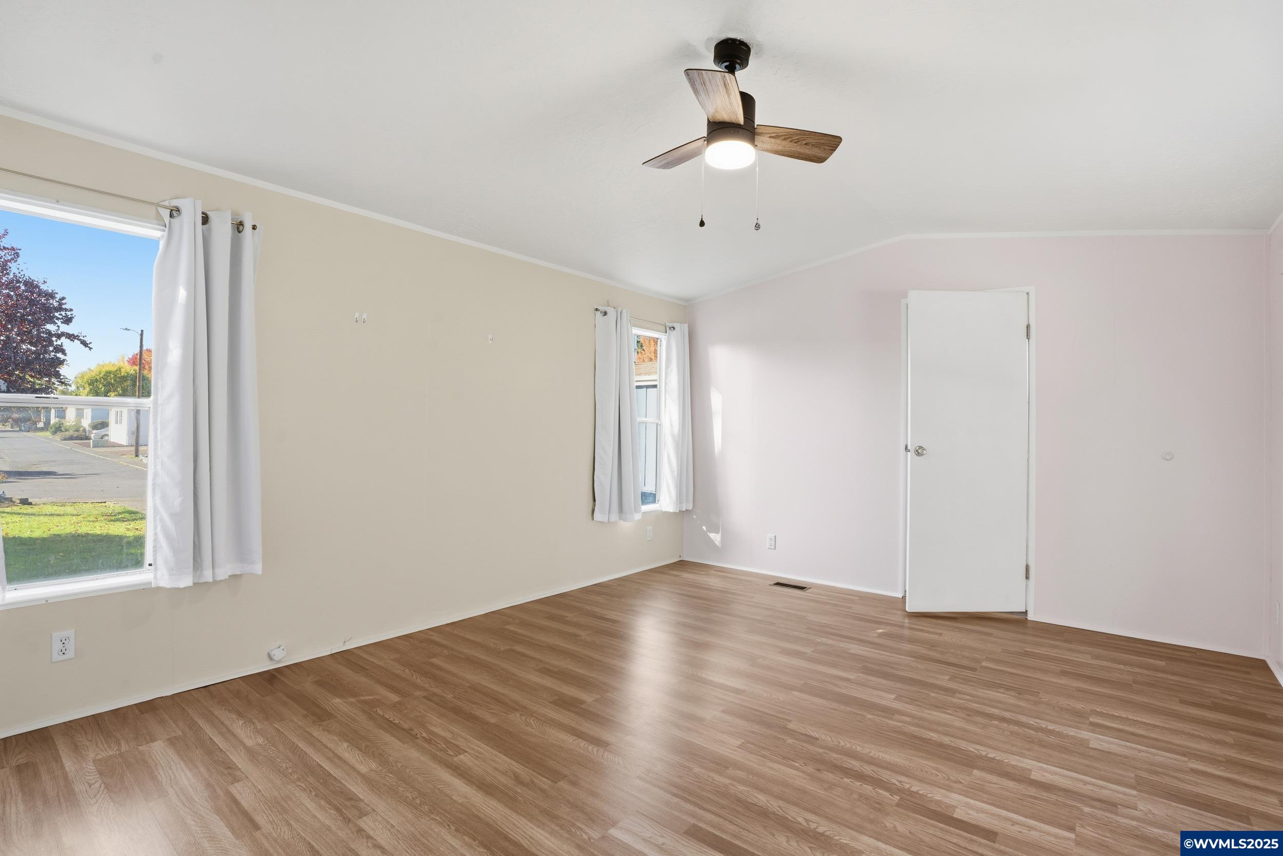 277 Edwards Road, Unit 145 Monmouth, OR 97361 - Photo 13 of 47 a view of empty room with wooden floor and window