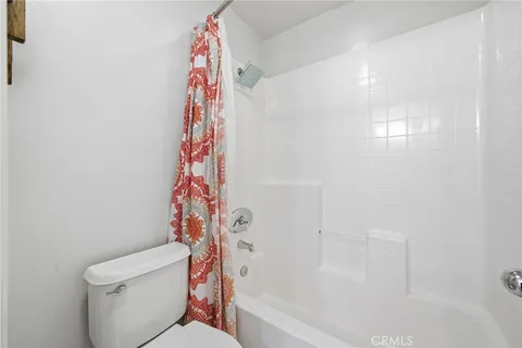 a living room with large windows and furniture