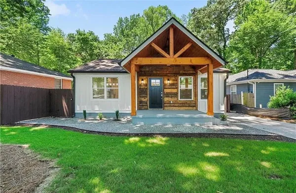 a front view of a house with a yard and porch