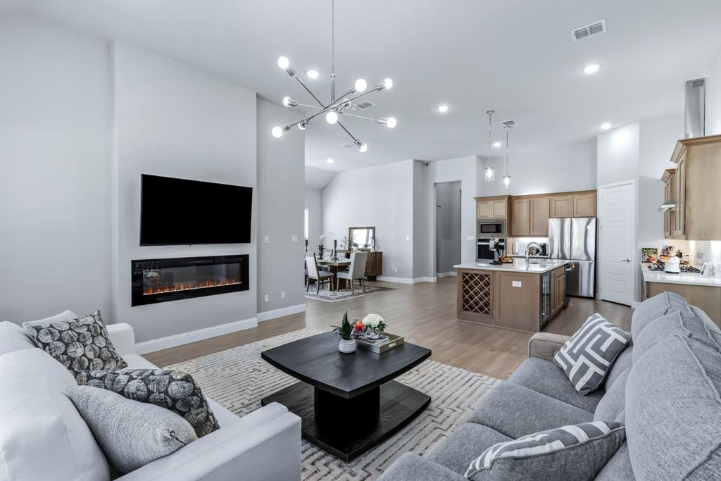 1302 Shorefront Drive Allen, TX 75013 - Photo 10 of 40 a living room with furniture and a flat screen tv