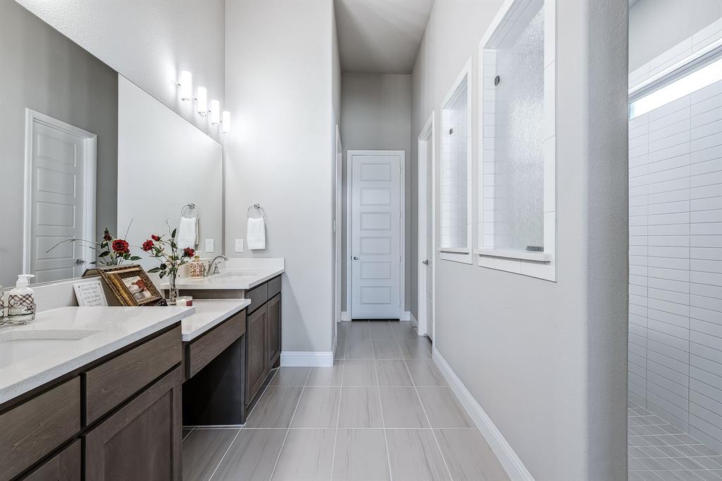 1302 Shorefront Drive Allen, TX 75013 - Photo 13 of 40 a spacious bathroom with a double vanity sink and a mirror