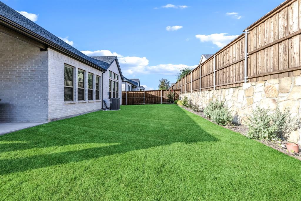 1302 Shorefront Drive Allen, TX 75013 - Photo 22 of 40 a view of backyard with garden and plants