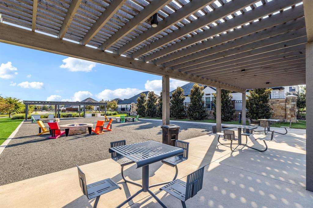 1302 Shorefront Drive Allen, TX 75013 - Photo 26 of 40 a view of a patio with a table and chairs and a barbeque