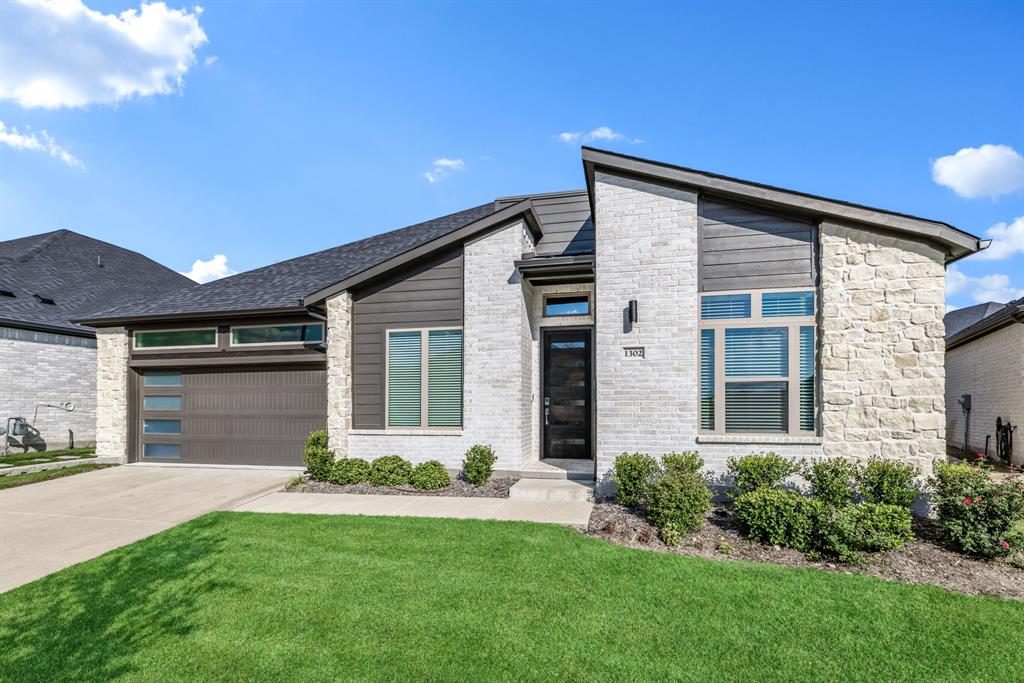 1302 Shorefront Drive Allen, TX 75013 - Photo 39 of 40 a front view of a house with a yard and garage