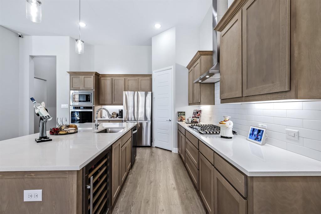 1302 Shorefront Drive Allen, TX 75013 - Photo 8 of 40 a kitchen with stainless steel appliances granite countertop a sink stove and cabinets