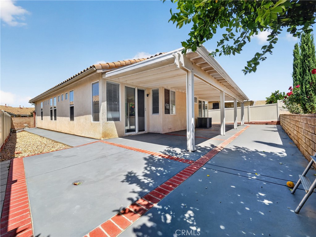 1436 Riviera Avenue Banning, CA 92220 - Photo 41 of 43 a view of a white house with a small yard and wooden fence