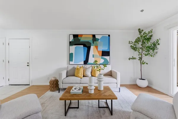 a living room with furniture and a potted plant