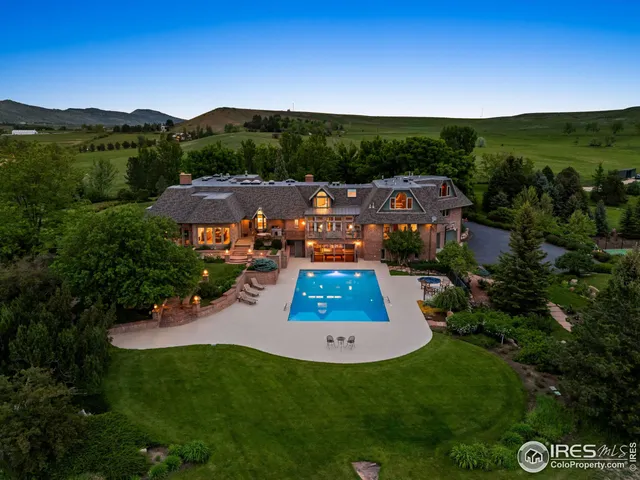 an aerial view of residential houses with outdoor space and trees