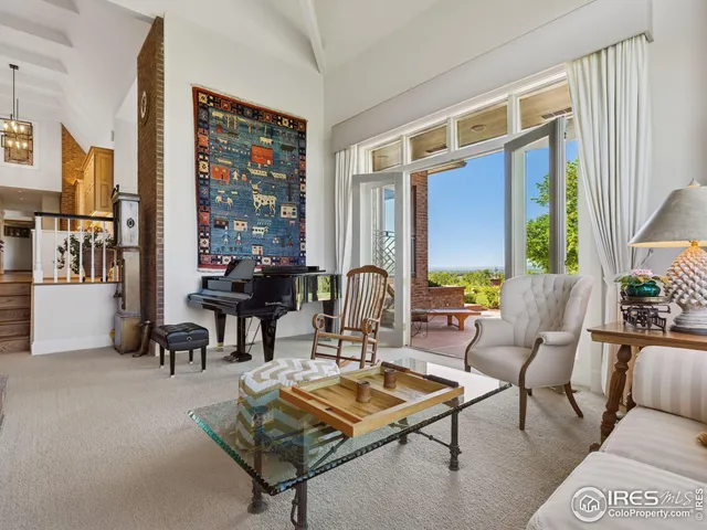 a living room with furniture a large window and a table