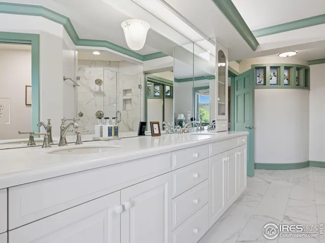 a bathroom with a double vanity sink and a mirror
